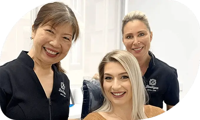 dental patient with care team Smiling dental patient with two dental care team members