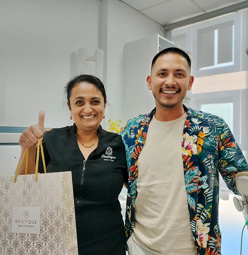 Dentist with a happy patient after dental treatment